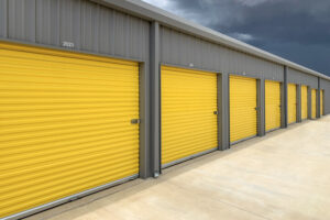 Commercial Garage Door Repair Franklin TN Exterior of a commercial warehouse with yellow roller doors