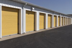 A set of yellow commercial garage doors all in a row.