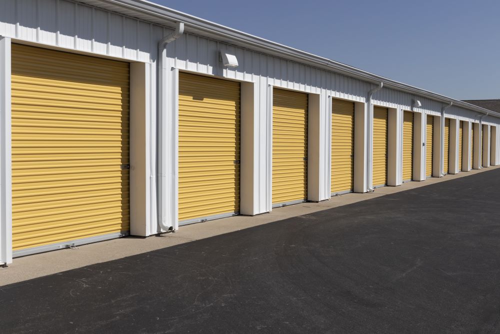 A row of yellow commercial garages.