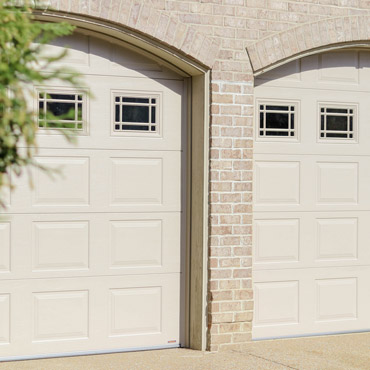 Brick home with two arched garage doors.